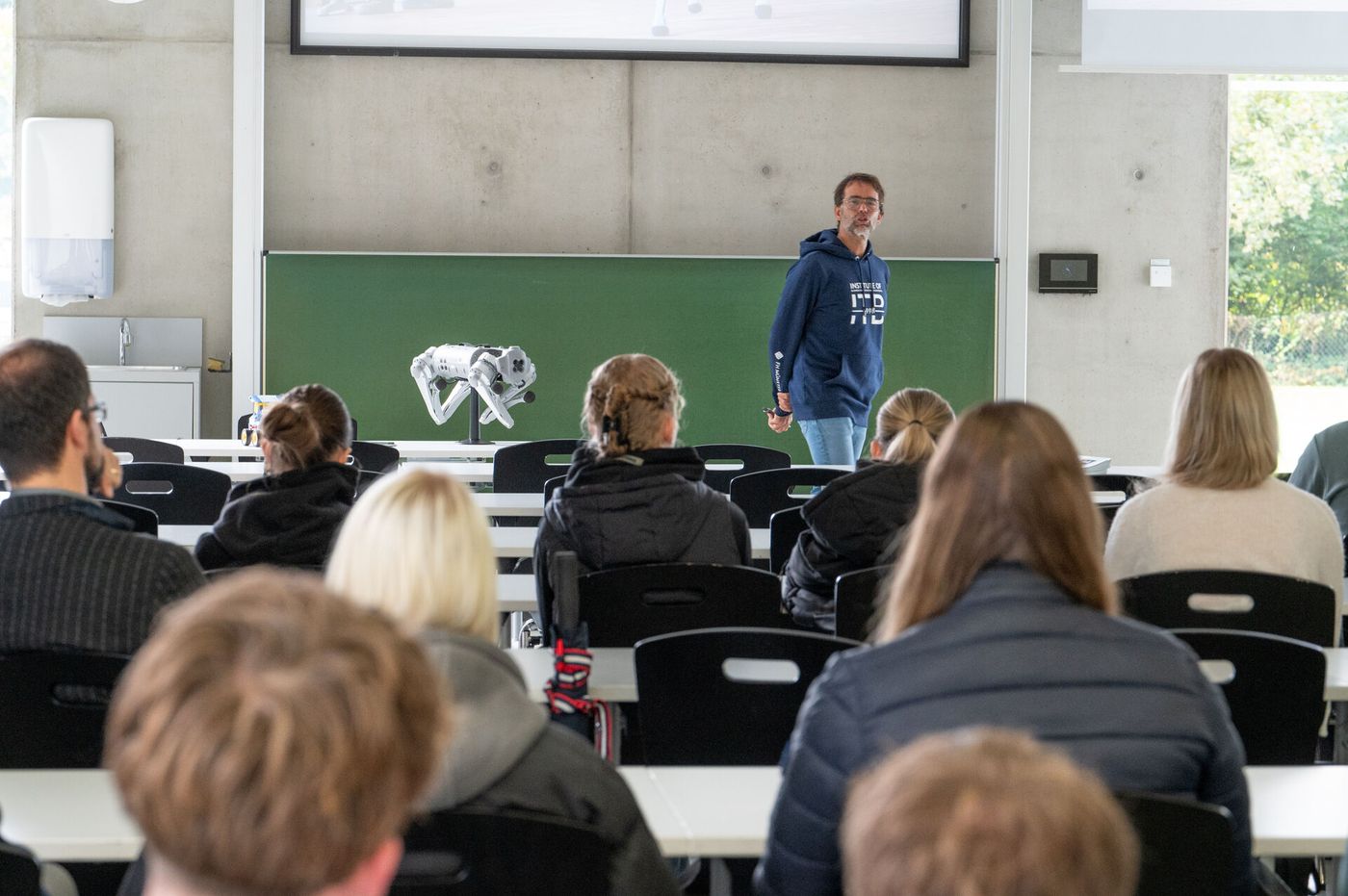 Ralf Ziegenbein spricht vor einer Gruppe Studieninteressierter.